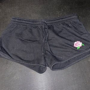 Gently used drawstring shorts with rose embroidery.